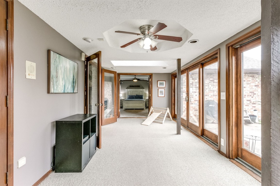 6201 Inland Road, Warr Acres, OK 73132 sunroom featuring ceiling fan, french doors, and a raised ceiling