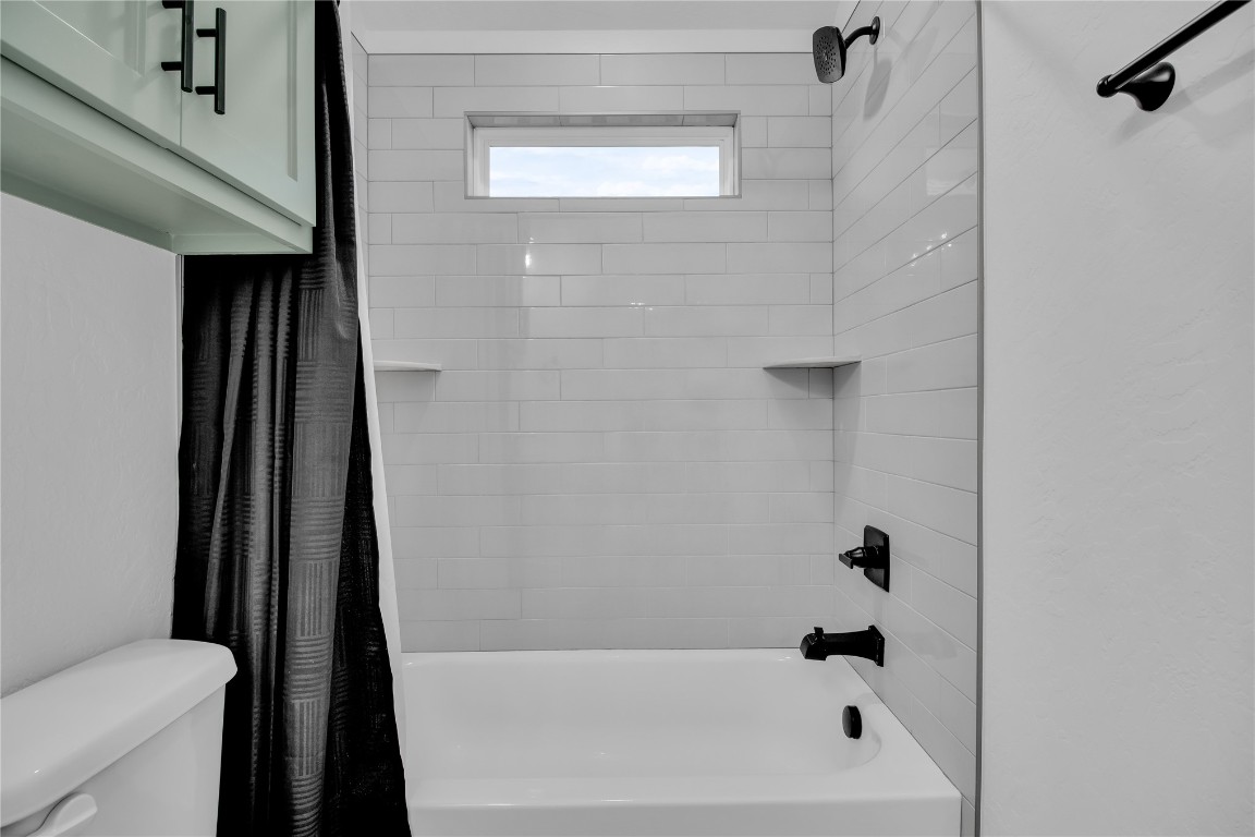 6516 NW 148th Street, Oklahoma City, OK 73142 bathroom with shower / bath combo and toilet