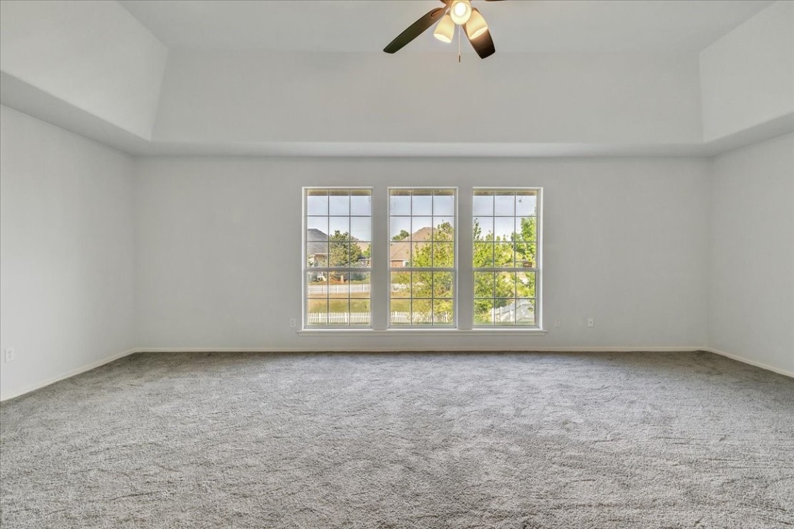 12824 Knight Hill Road, Oklahoma City, OK 73142 carpeted empty room featuring ceiling fan