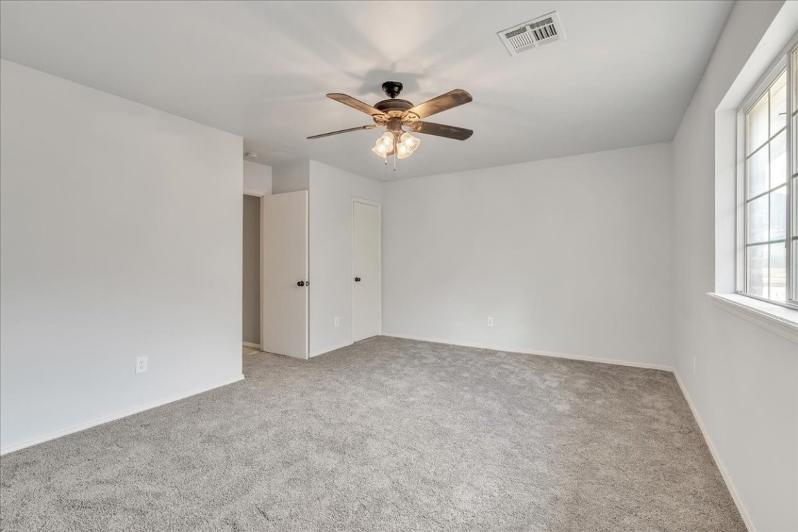 12824 Knight Hill Road, Oklahoma City, OK 73142 carpeted empty room with ceiling fan