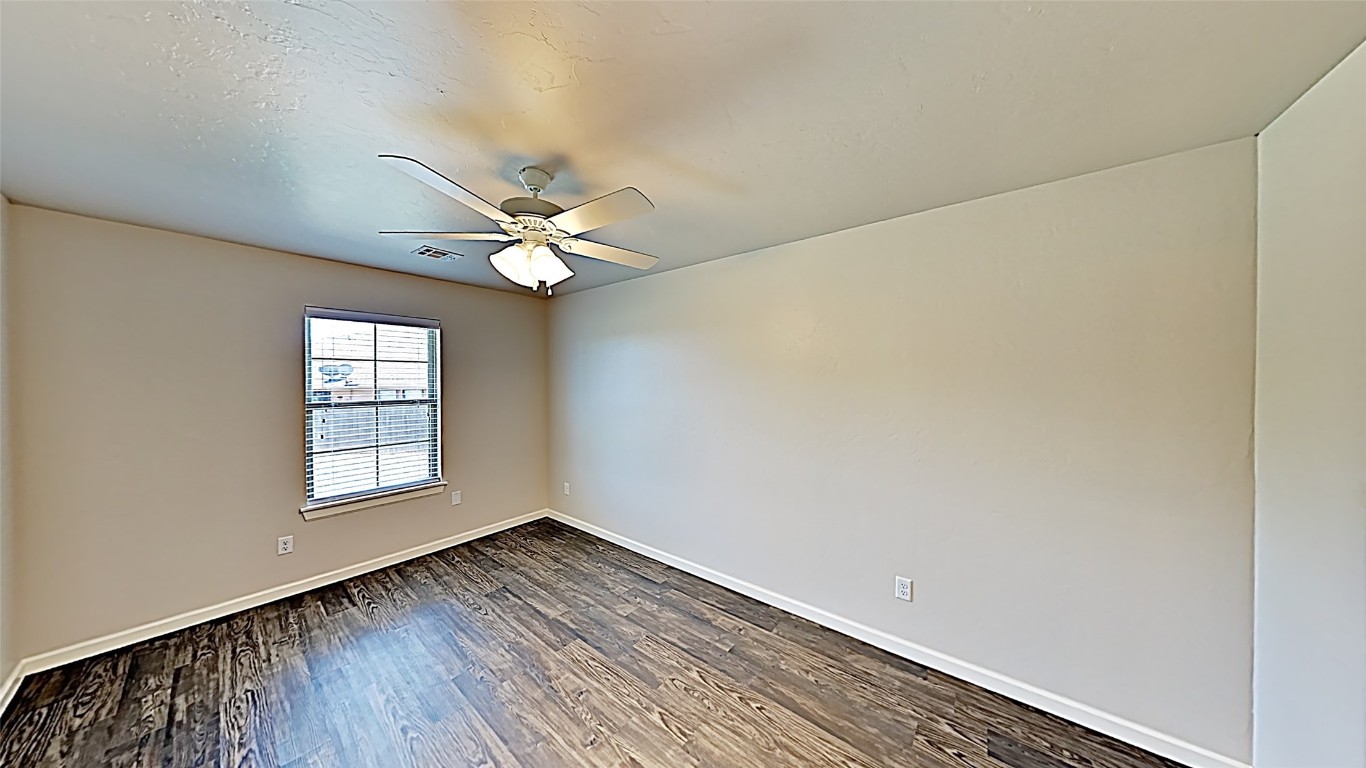 11521 Keystone Circle, Oklahoma City, OK 73114 empty room featuring dark wood-type flooring and ceiling fan