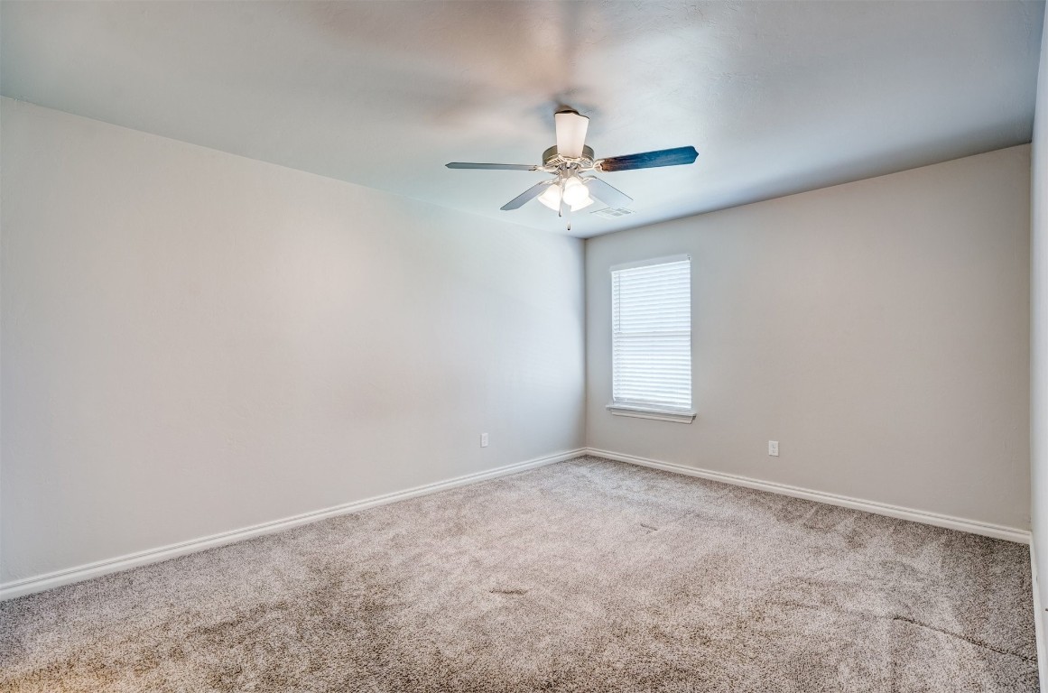 340 NW 97th Street, Oklahoma City, OK 73114 unfurnished room featuring light carpet and ceiling fan