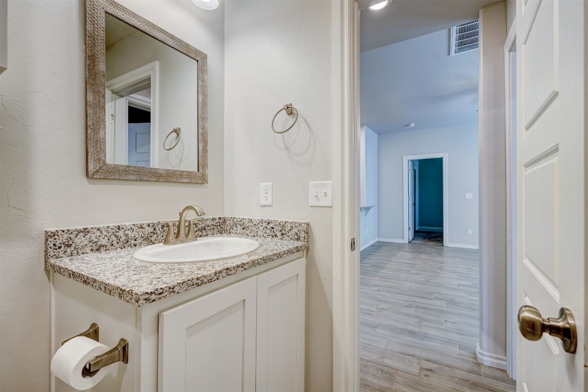 340 NW 97th Street, Oklahoma City, OK 73114 bathroom with wood-type flooring and vanity