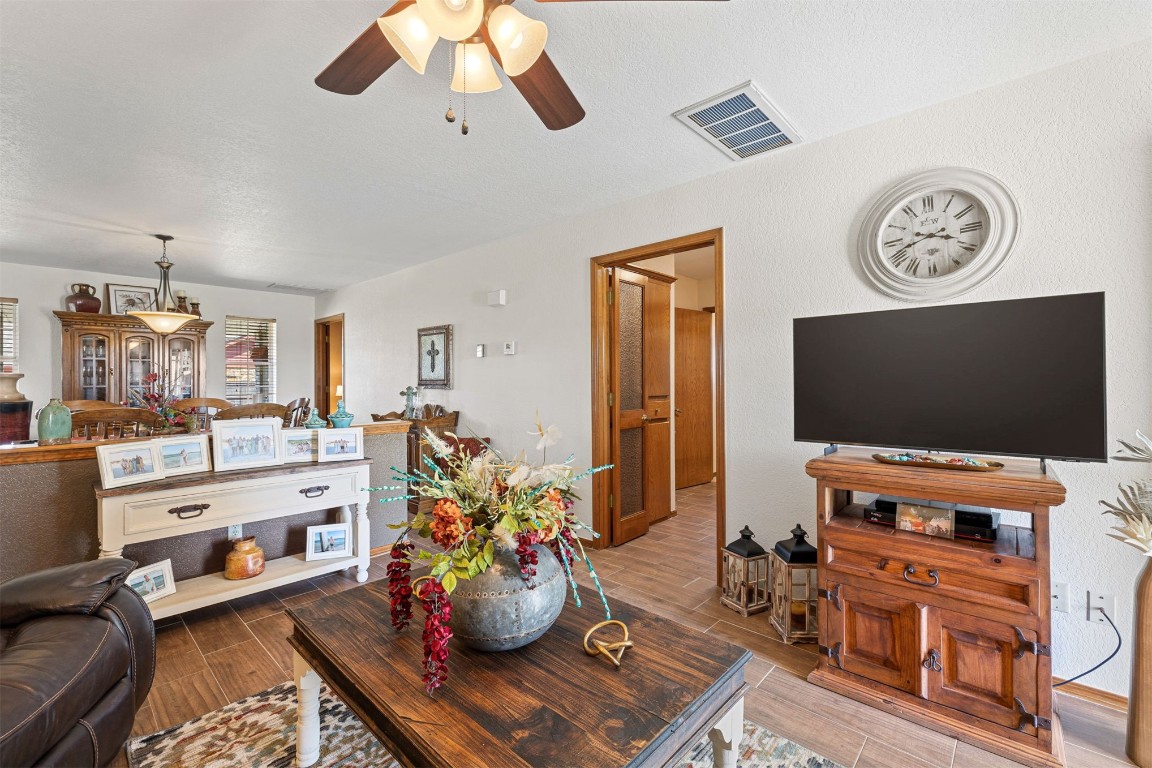 1524 W Oak Street, El Reno, OK 73036 living room with light hardwood / wood-style floors and ceiling fan