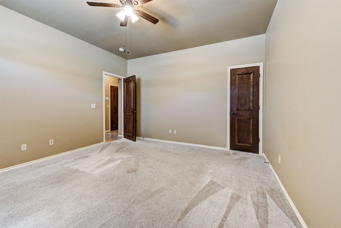 12600 N Rockwell Avenue, #78, Oklahoma City, OK 73142 unfurnished room featuring light colored carpet and ceiling fan