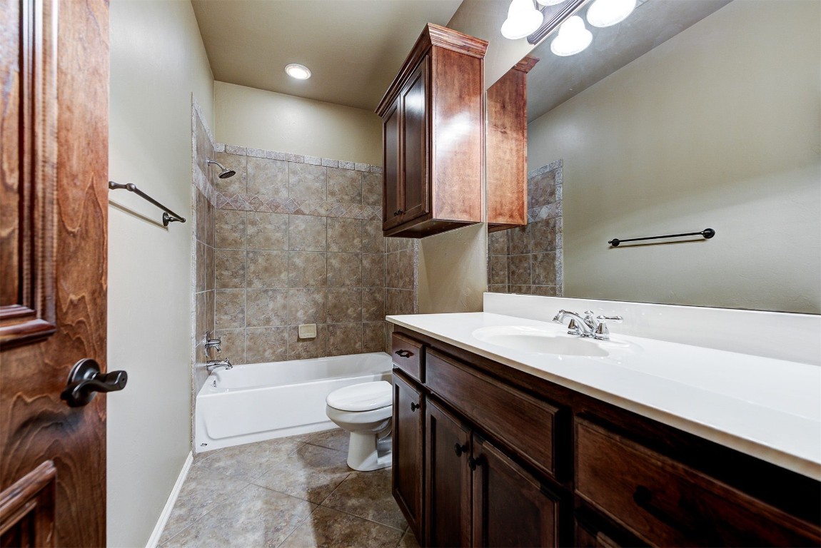 12600 N Rockwell Avenue, #78, Oklahoma City, OK 73142 full bathroom featuring tile flooring, vanity, tiled shower / bath combo, and toilet
