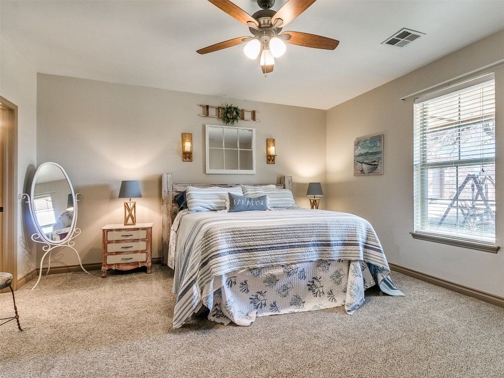 2350 Gina Court, Guthrie, OK 73044 bedroom featuring light colored carpet, ceiling fan, and multiple windows