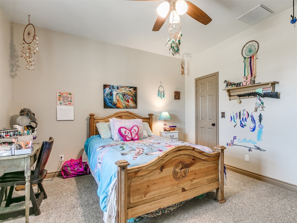 2350 Gina Court, Guthrie, OK 73044 bedroom with light colored carpet and ceiling fan