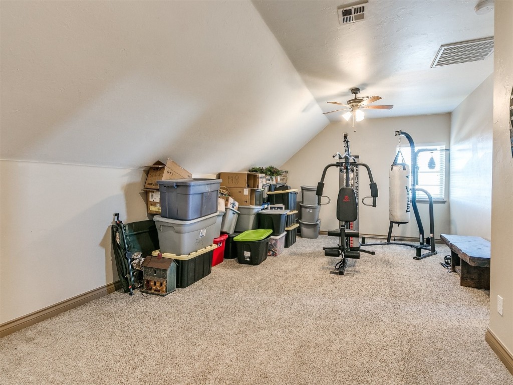 2350 Gina Court, Guthrie, OK 73044 workout room with lofted ceiling, ceiling fan, and carpet
