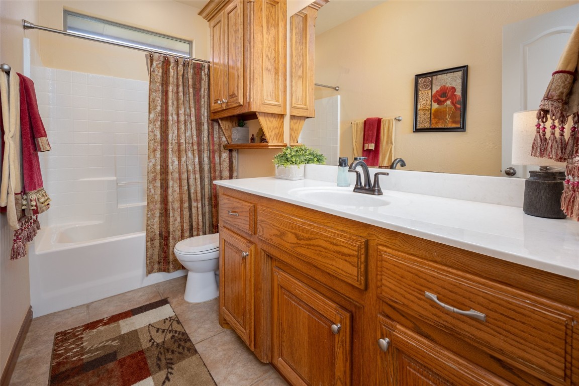 3300 Red Maple Lane, Moore, OK 73170 full bathroom featuring shower / tub combo with curtain, toilet, vanity with extensive cabinet space, and tile flooring