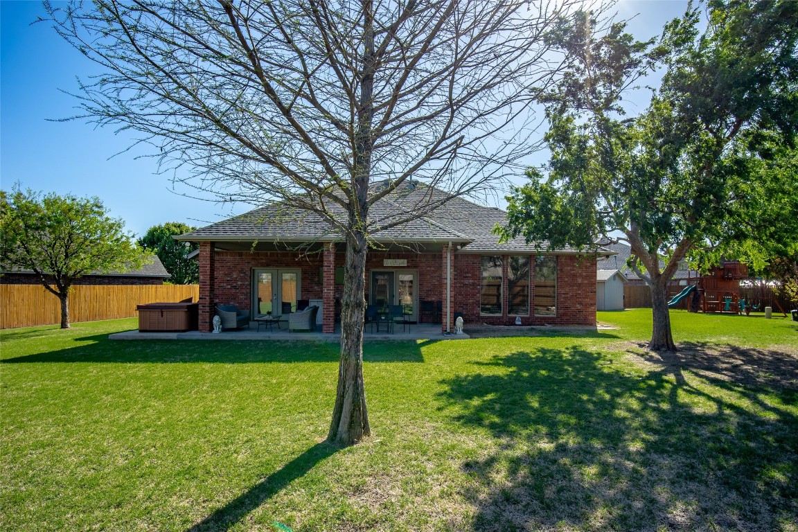 3300 Red Maple Lane, Moore, OK 73170 back of house with a patio, a yard, and a playground