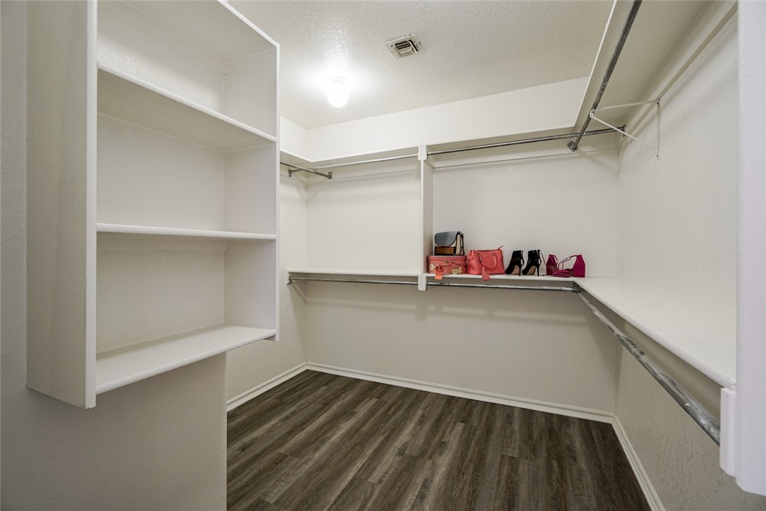 300 Glen Drive, Yukon, OK 73099 spacious closet with dark hardwood / wood-style flooring