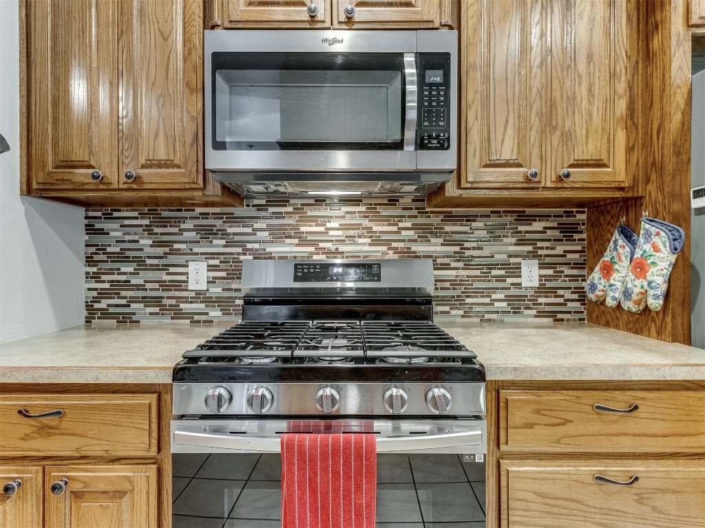1161 Mill Ridge Drive, Blanchard, OK 73010 kitchen with backsplash, stainless steel appliances, and tile floors