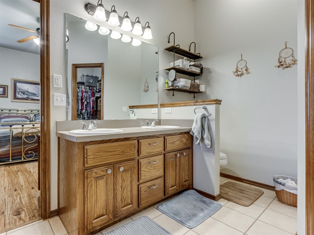 1161 Mill Ridge Drive, Blanchard, OK 73010 bathroom featuring toilet, tile flooring, ceiling fan, and dual vanity