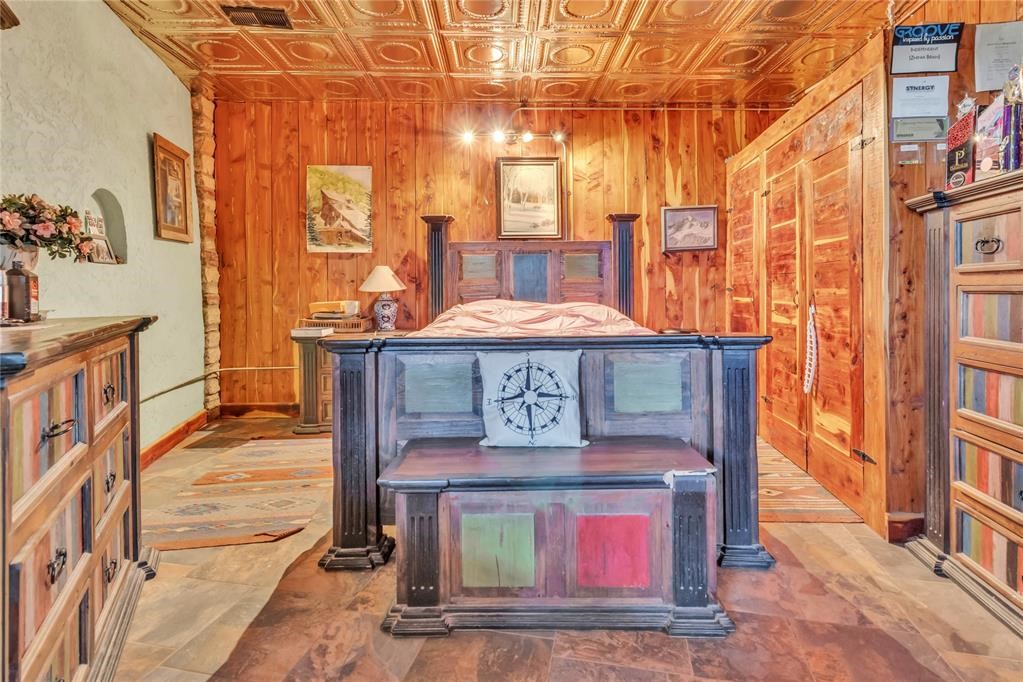 7676 W County Road 66, Mulhall, OK 73063 interior space with wooden walls and coffered ceiling