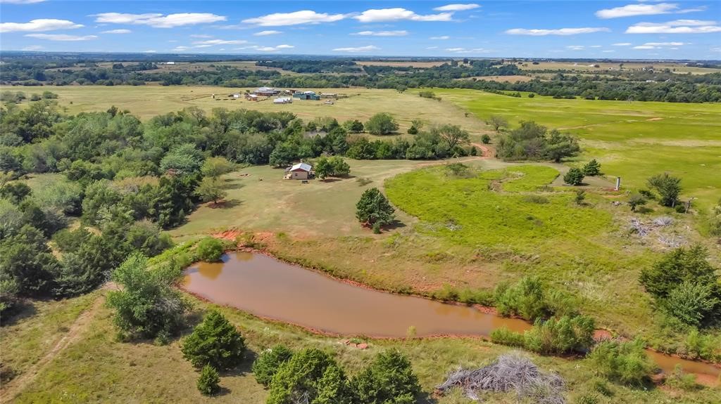 7676 W County Road 66, Mulhall, OK 73063 drone / aerial view with a water view and a rural view