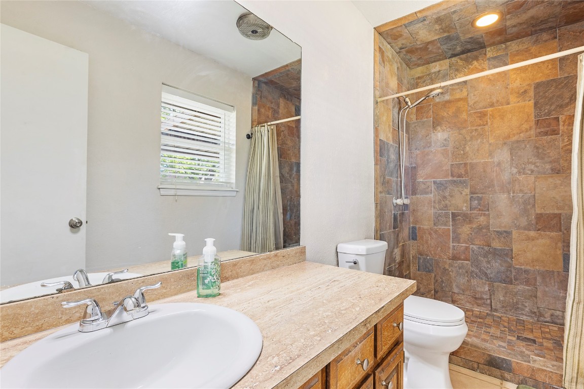 1601 Whispering Creek Drive, Edmond, OK 73013 bathroom featuring walk in shower, tile floors, toilet, and large vanity