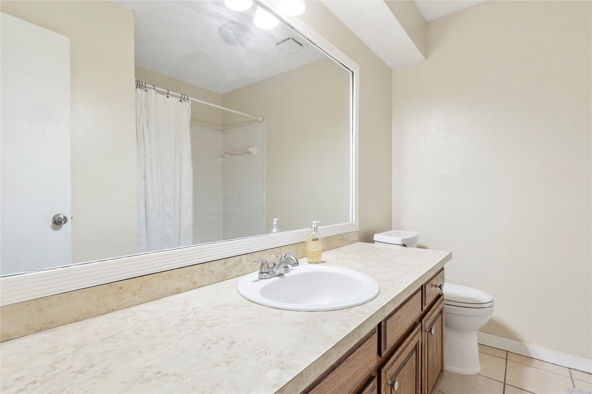 1601 Whispering Creek Drive, Edmond, OK 73013 bathroom with toilet, tile floors, and large vanity