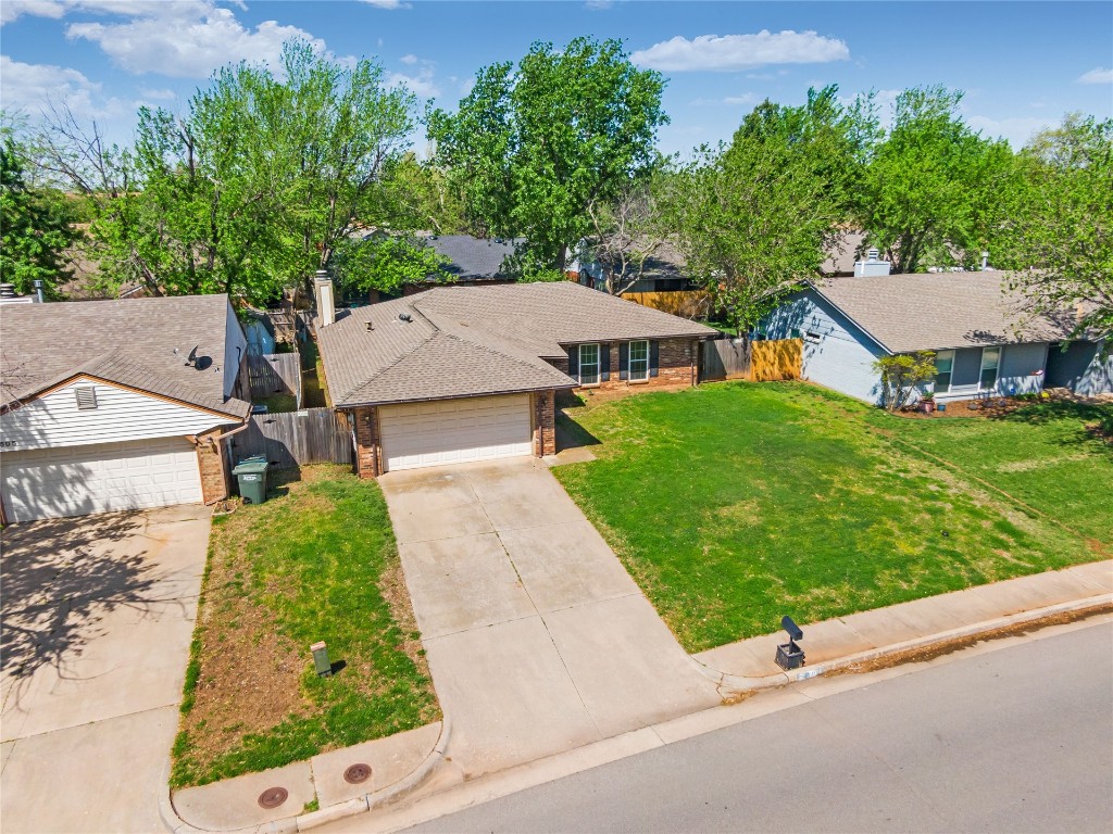 1601 Whispering Creek Drive, Edmond, OK 73013 single story home with a garage and a front lawn