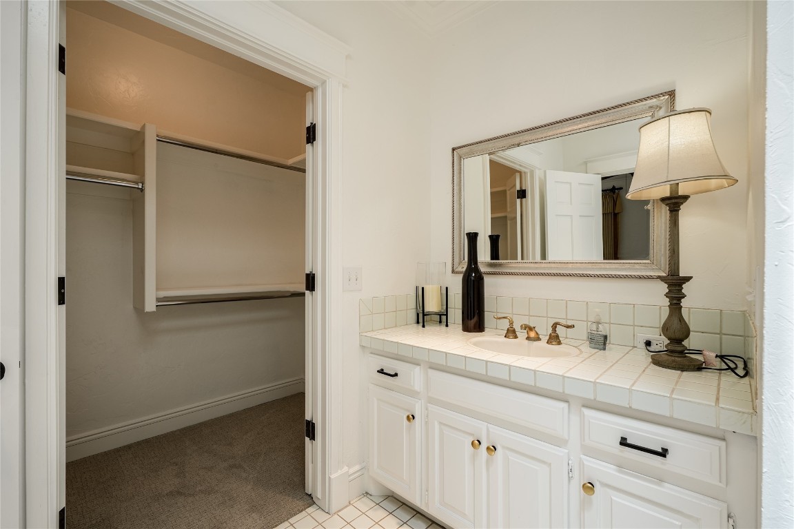 6324 Harden Drive, Oklahoma City, OK 73118 bathroom featuring tasteful backsplash, tile flooring, and vanity