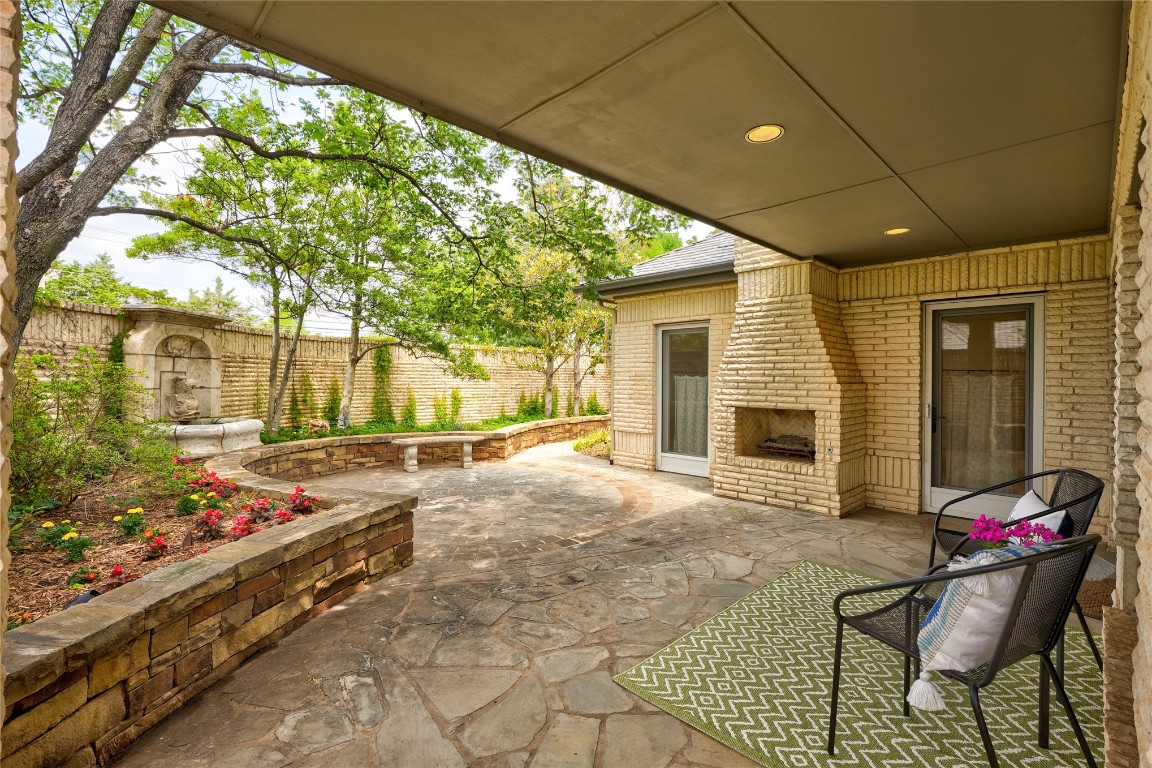 6324 Harden Drive, Oklahoma City, OK 73118 view of patio with an outdoor brick fireplace