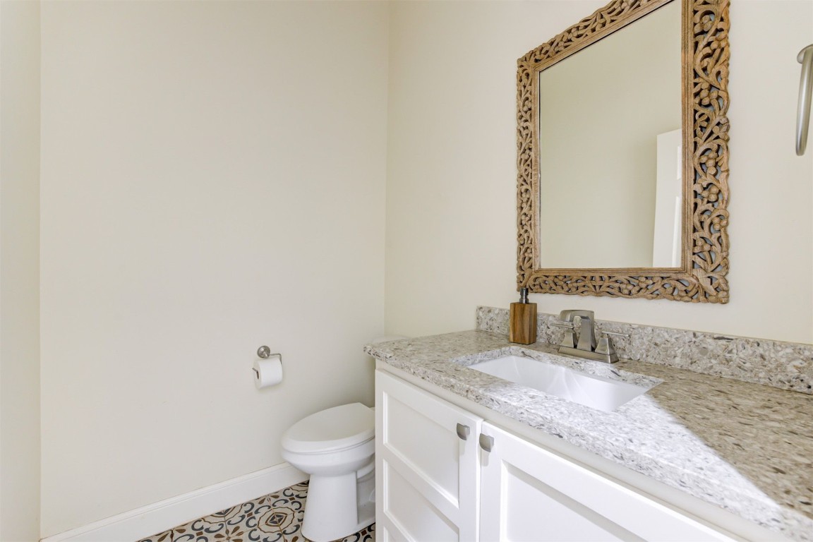 12712 Bristlecone Pine Boulevard, Oklahoma City, OK 73142 bathroom with tile floors, toilet, and oversized vanity
