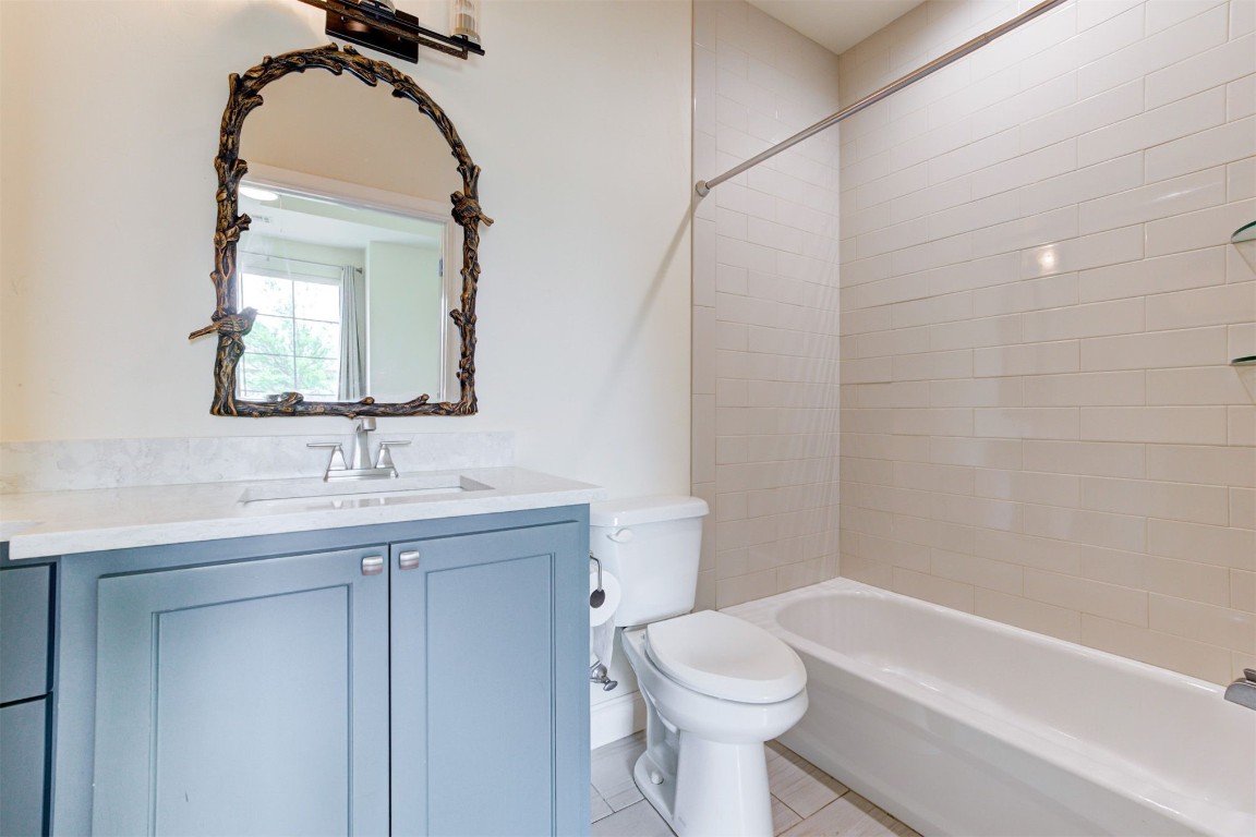 12712 Bristlecone Pine Boulevard, Oklahoma City, OK 73142 full bathroom with tiled shower / bath combo, tile flooring, vanity, and toilet