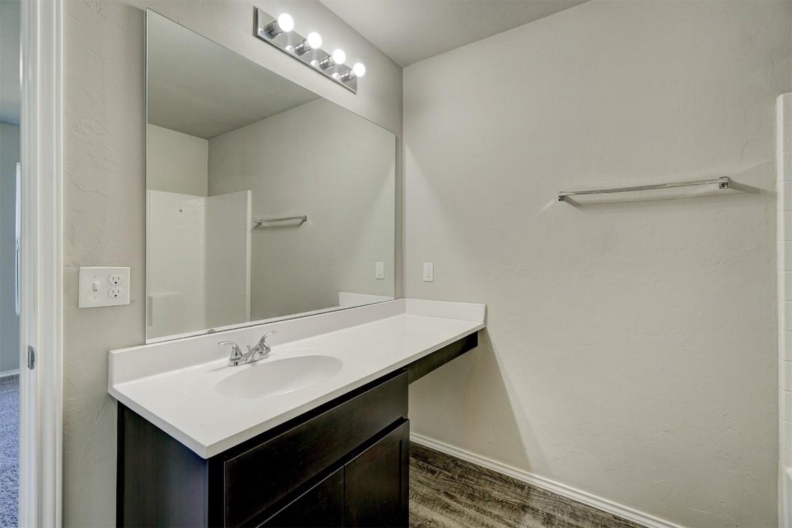 10005 Ruger Road, Yukon, OK 73099 bathroom featuring wood-type flooring and vanity