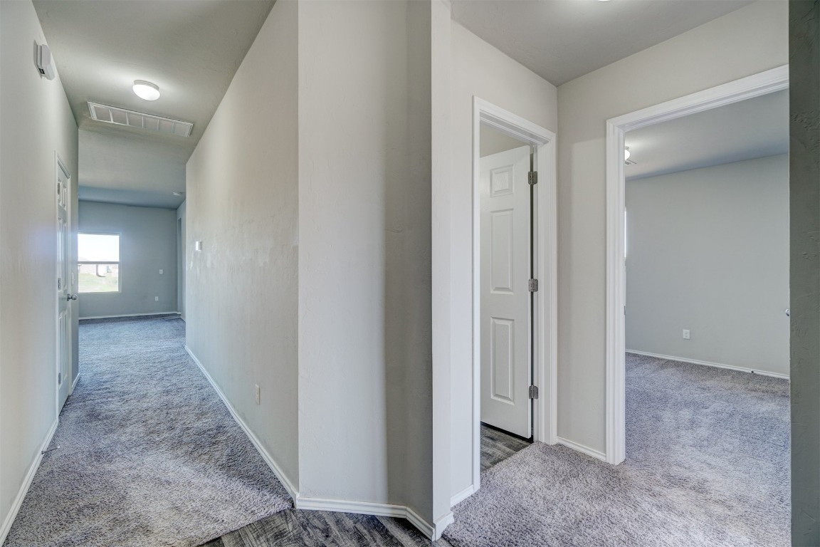10005 Ruger Road, Yukon, OK 73099 hallway with light colored carpet