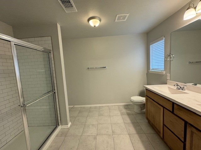 405 Vista Drive, Yukon, OK 73099 bathroom featuring an enclosed shower, toilet, tile flooring, and vanity