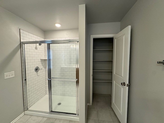 405 Vista Drive, Yukon, OK 73099 bathroom featuring a shower with door and tile floors
