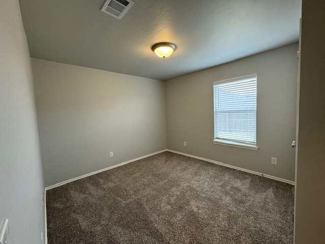405 Vista Drive, Yukon, OK 73099 unfurnished room with dark colored carpet