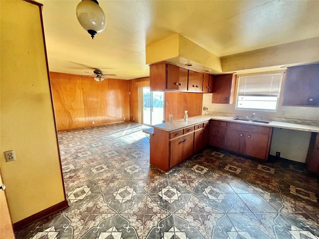 606 S Carnegie Street, Carnegie, OK 73015 kitchen featuring sink, dark tile flooring, and ceiling fan