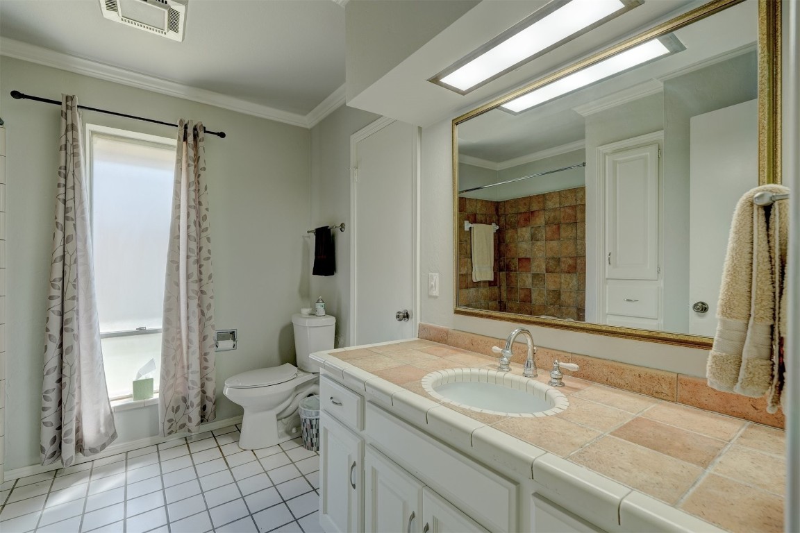 3925 Tamarisk Drive, Oklahoma City, OK 73120 full bathroom featuring shower / tub combo, toilet, tile floors, ornamental molding, and vanity