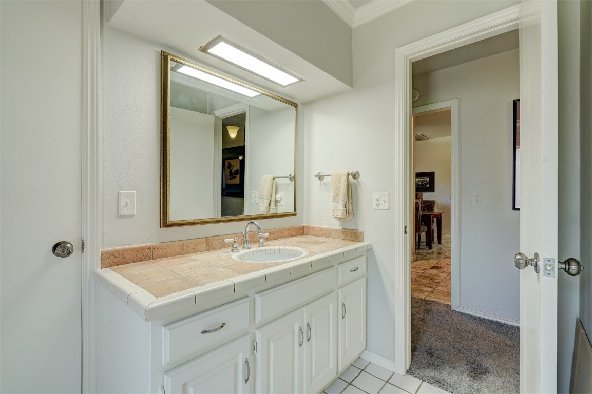 3925 Tamarisk Drive, Oklahoma City, OK 73120 full bathroom with tile flooring, shower / bath combination with curtain, toilet, ornamental molding, and vanity