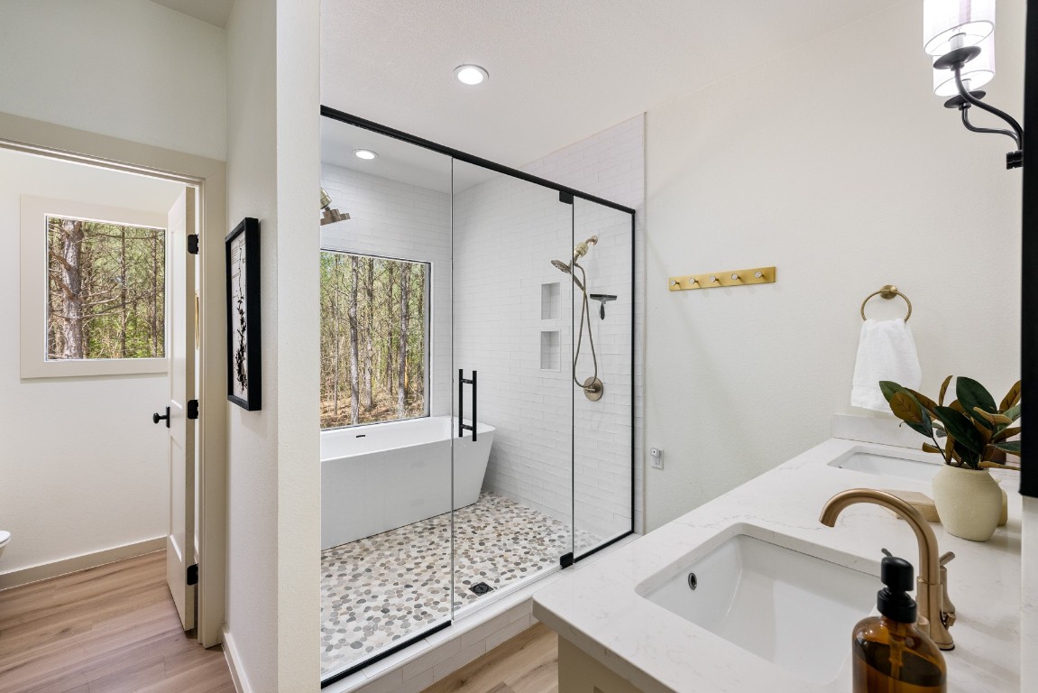 157 Red Fern Trail, Broken Bow, OK 74728 bathroom with wood-type flooring, dual bowl vanity, and plus walk in shower