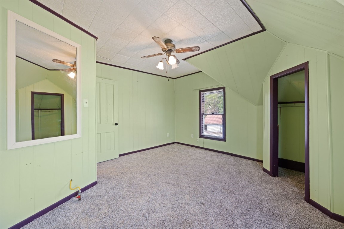 1902 W Noble Avenue, Guthrie, OK 73044 unfurnished bedroom with light colored carpet and ceiling fan
