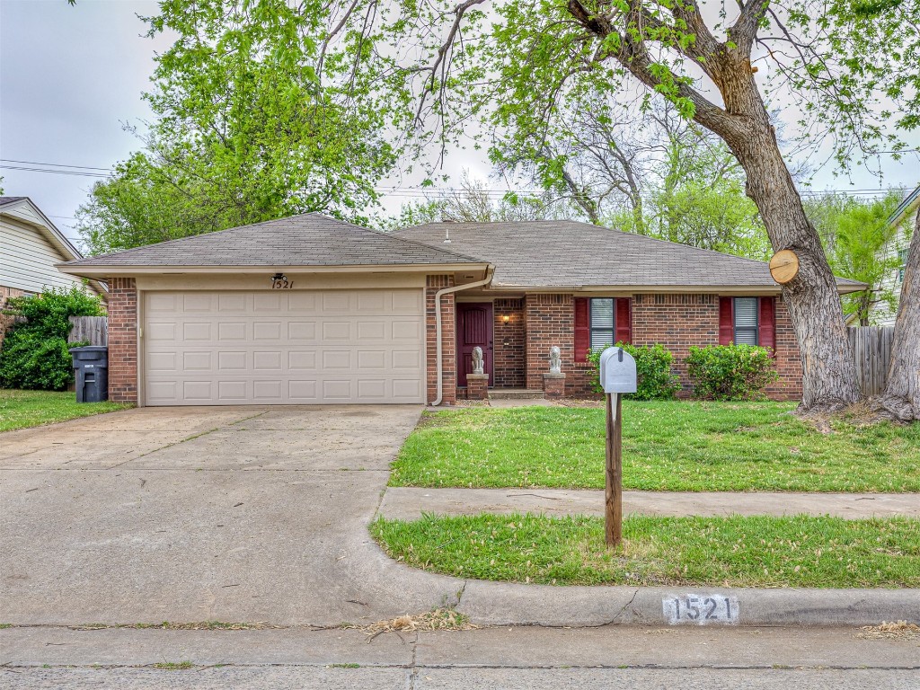1521 NE 3rd Street, Moore, OK 73160 single story home with a garage and a front lawn