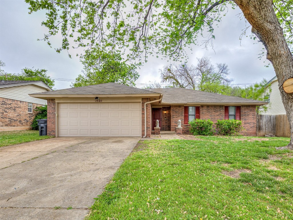 1521 NE 3rd Street, Moore, OK 73160 ranch-style house with a garage and a front lawn