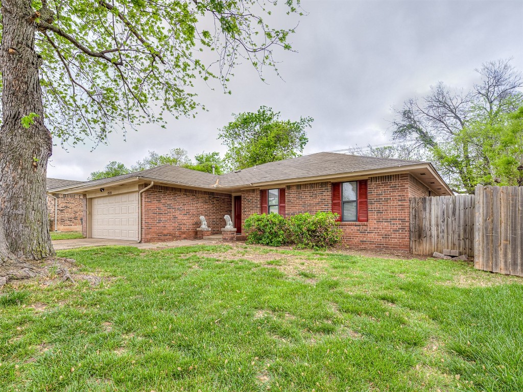 1521 NE 3rd Street, Moore, OK 73160 ranch-style home featuring a garage and a front yard