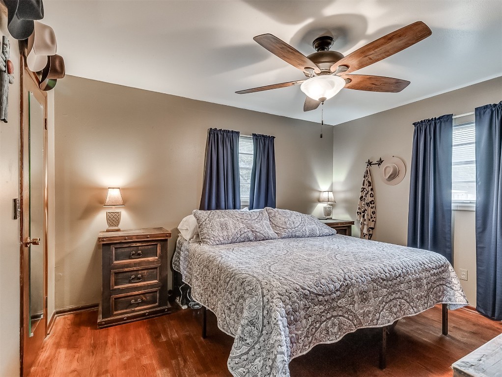 639 Ridgecrest Road, Edmond, OK 73013 bedroom with dark hardwood / wood-style floors and ceiling fan