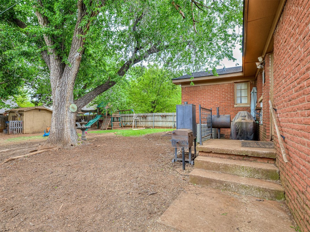 639 Ridgecrest Road, Edmond, OK 73013 view of yard featuring a storage shed and a playground