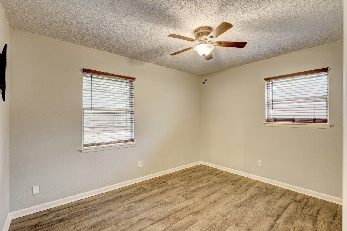 704 Juniper Avenue, Midwest City, OK 73130 spare room featuring ceiling fan, light hardwood / wood-style flooring, and a textured ceiling