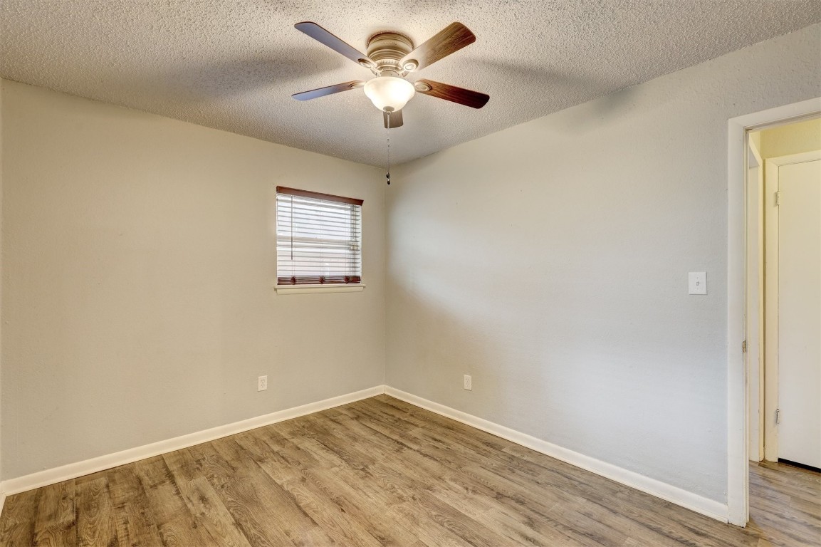 704 Juniper Avenue, Midwest City, OK 73130 empty room featuring light hardwood / wood-style flooring, ceiling fan, and a textured ceiling
