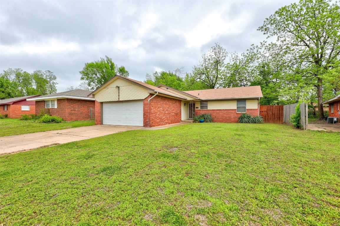 704 Juniper Avenue, Midwest City, OK 73130 single story home with a front lawn and a garage
