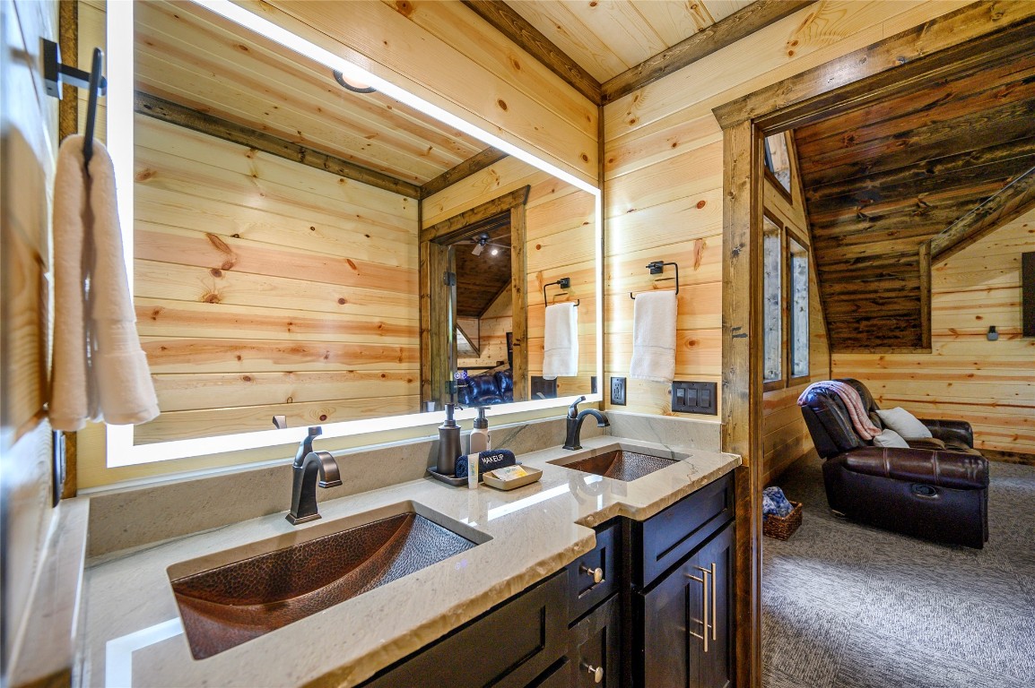 41 Oak Creek Trail, Broken Bow, OK 74728 bathroom with wood ceiling, vanity, and wooden walls