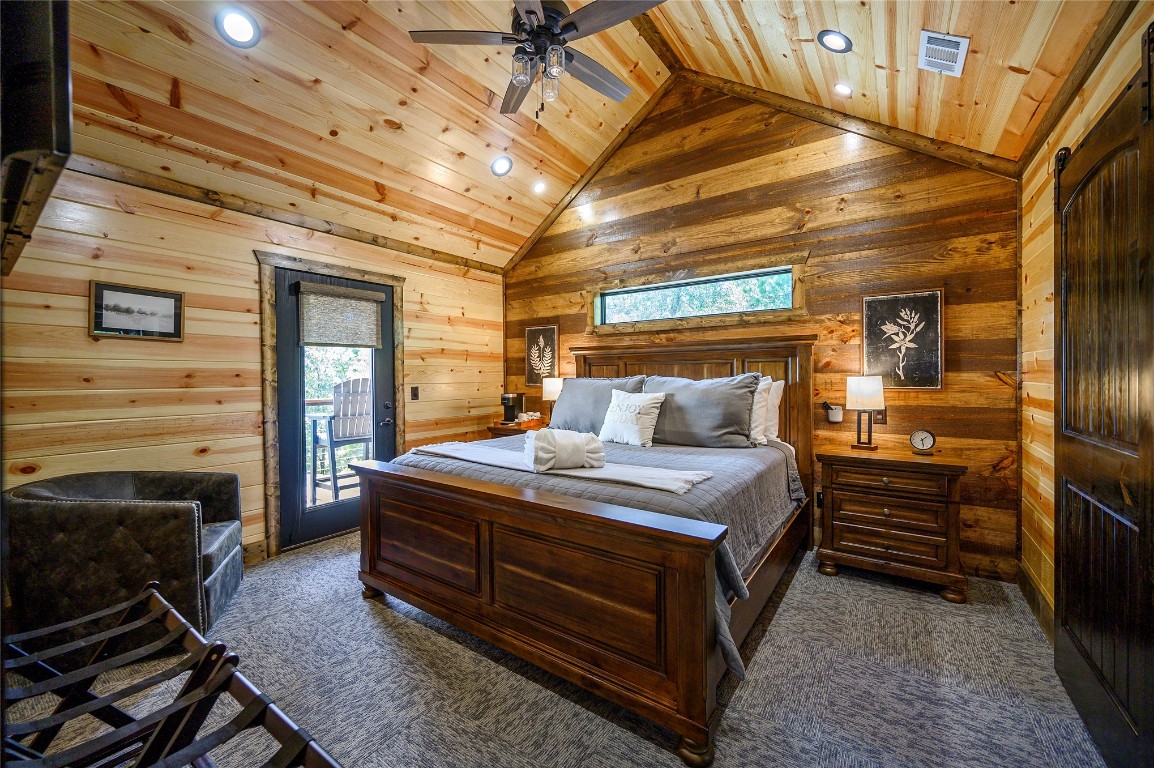 41 Oak Creek Trail, Broken Bow, OK 74728 bedroom with ceiling fan, high vaulted ceiling, access to exterior, dark colored carpet, and wooden ceiling