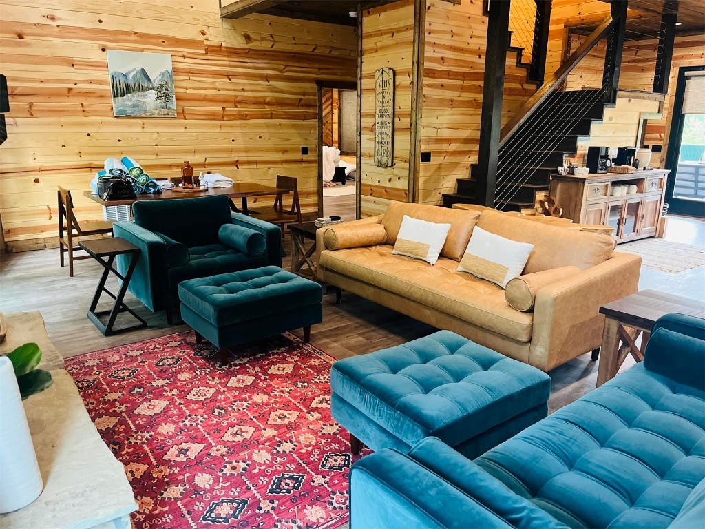 41 Oak Creek Trail, Broken Bow, OK 74728 living room featuring wood walls and hardwood / wood-style flooring