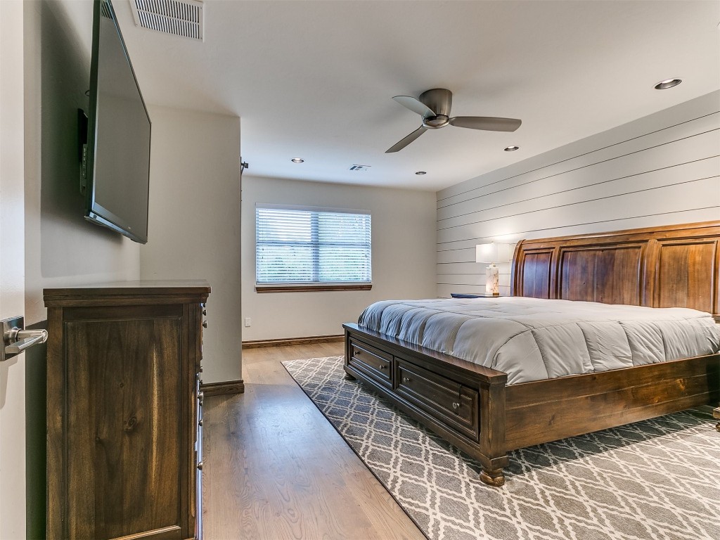 609 S Chloe Lane, Mustang, OK 73064 bedroom with wood-type flooring and ceiling fan