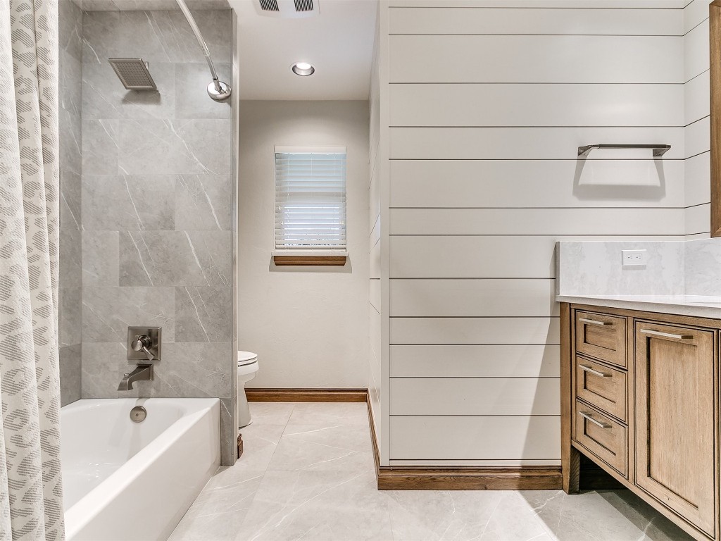 609 S Chloe Lane, Mustang, OK 73064 full bathroom with shower / bath combo, vanity, tile floors, and toilet